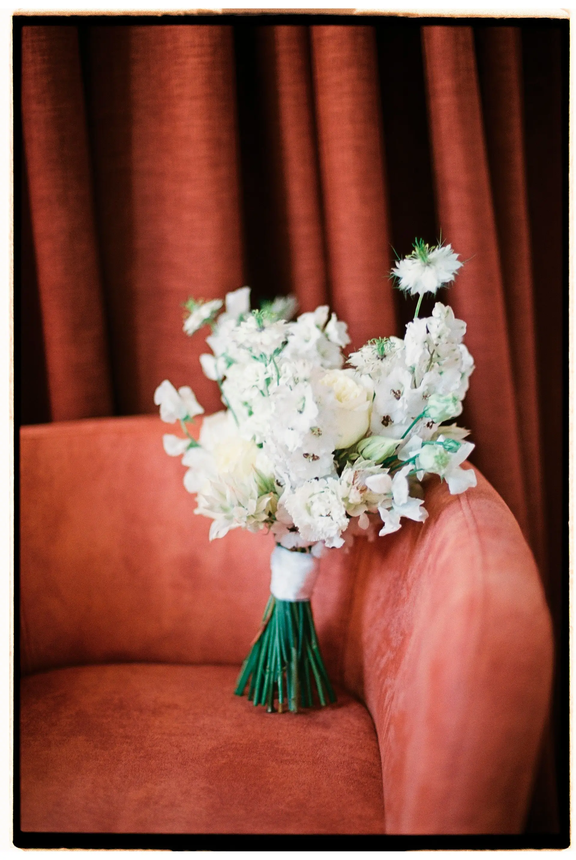 Elegant white floral arrangement in a sunlit studio